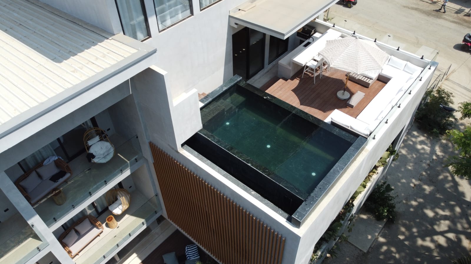 Drone shot of penthouse infinity pool and suite balconies