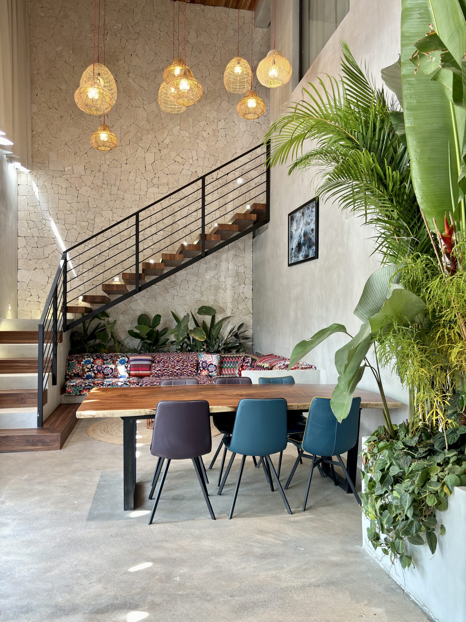 Double-height dining room with pendant lights and stairs