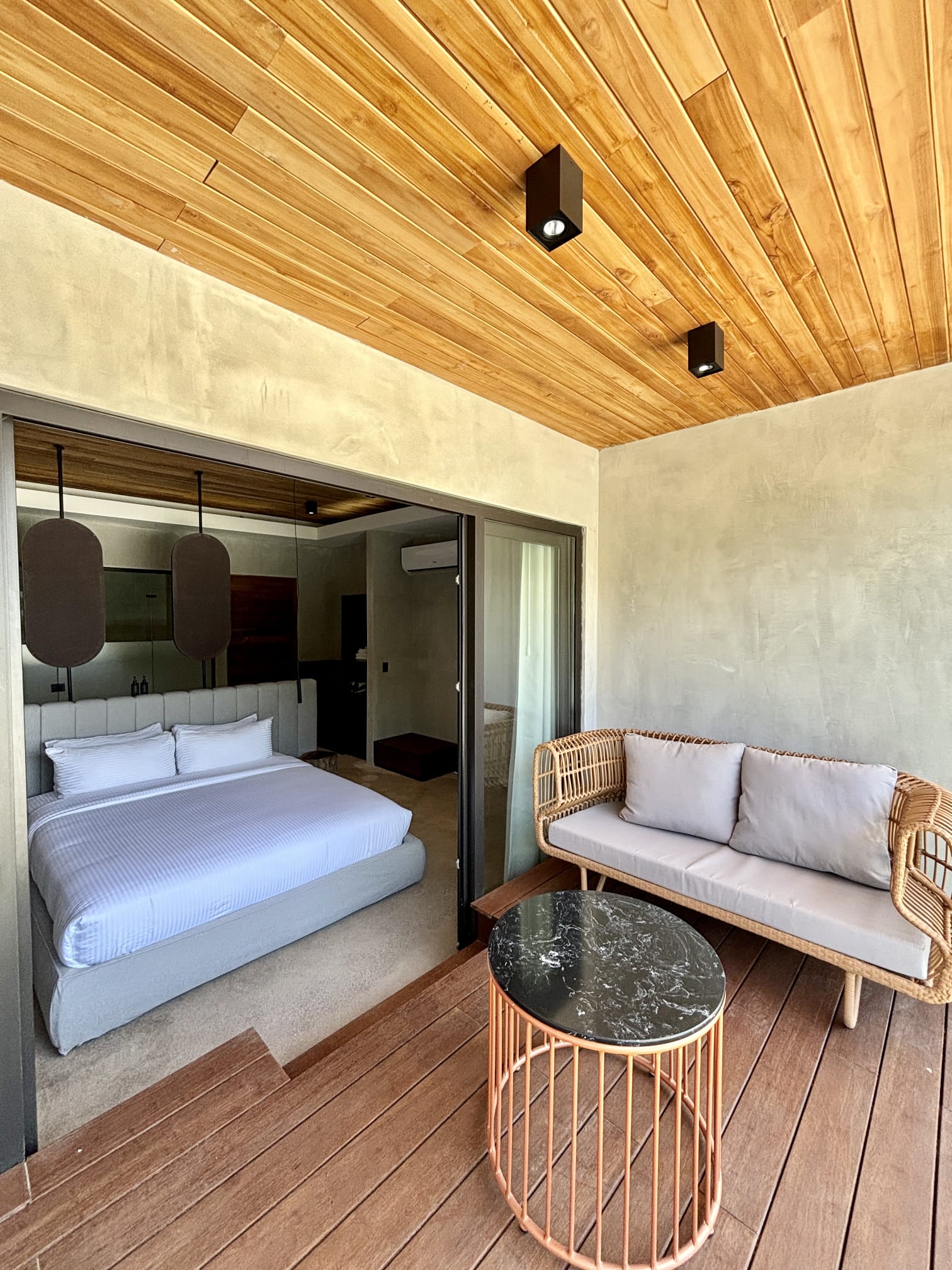 Suite bedroom with private rattan terrace