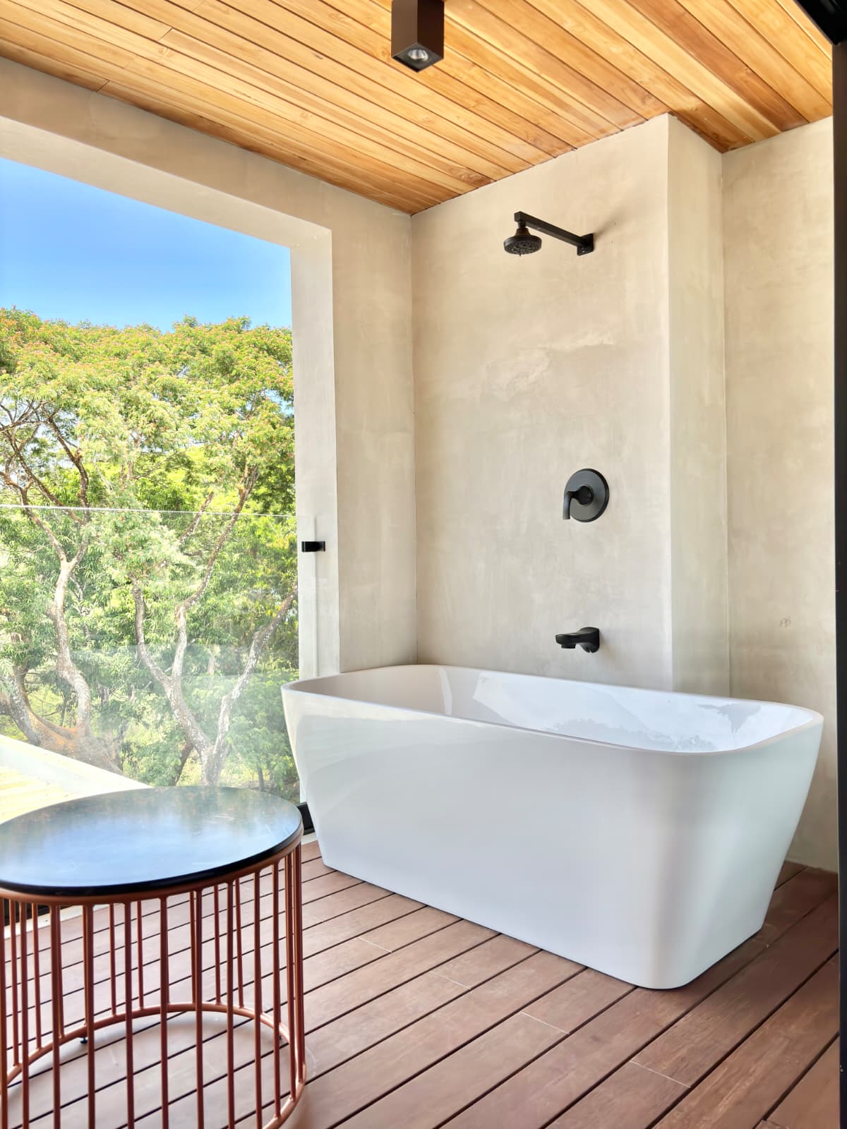 Freestanding bathtub over the jungle canopy