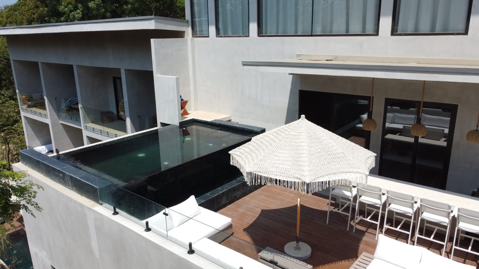 Aerial view of penthouse infinity pool above suite balconies