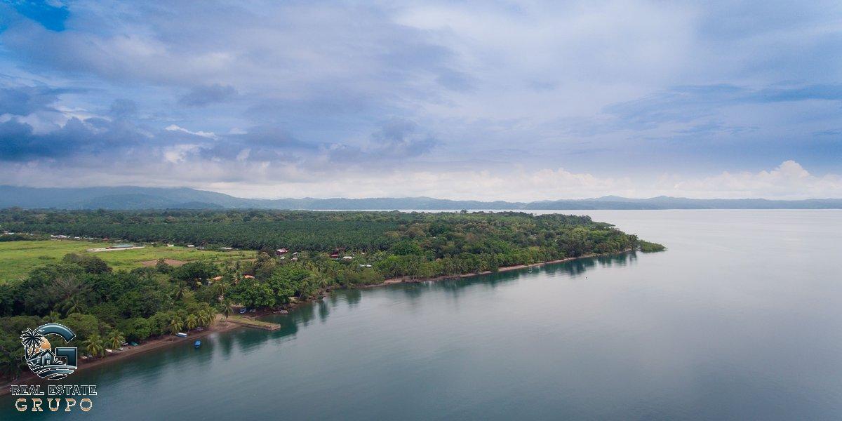 Aerial lush coastal landscape and island - where to buy real estate in costa rica