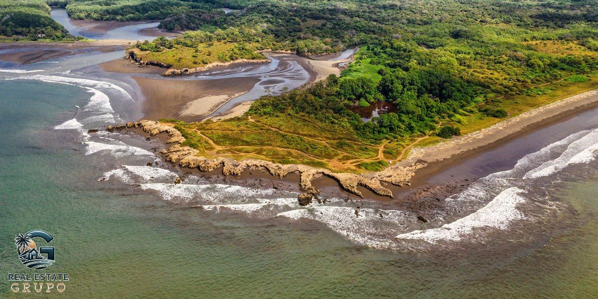 Aerial Puntarenas coastline with greenery - check property title costa rica