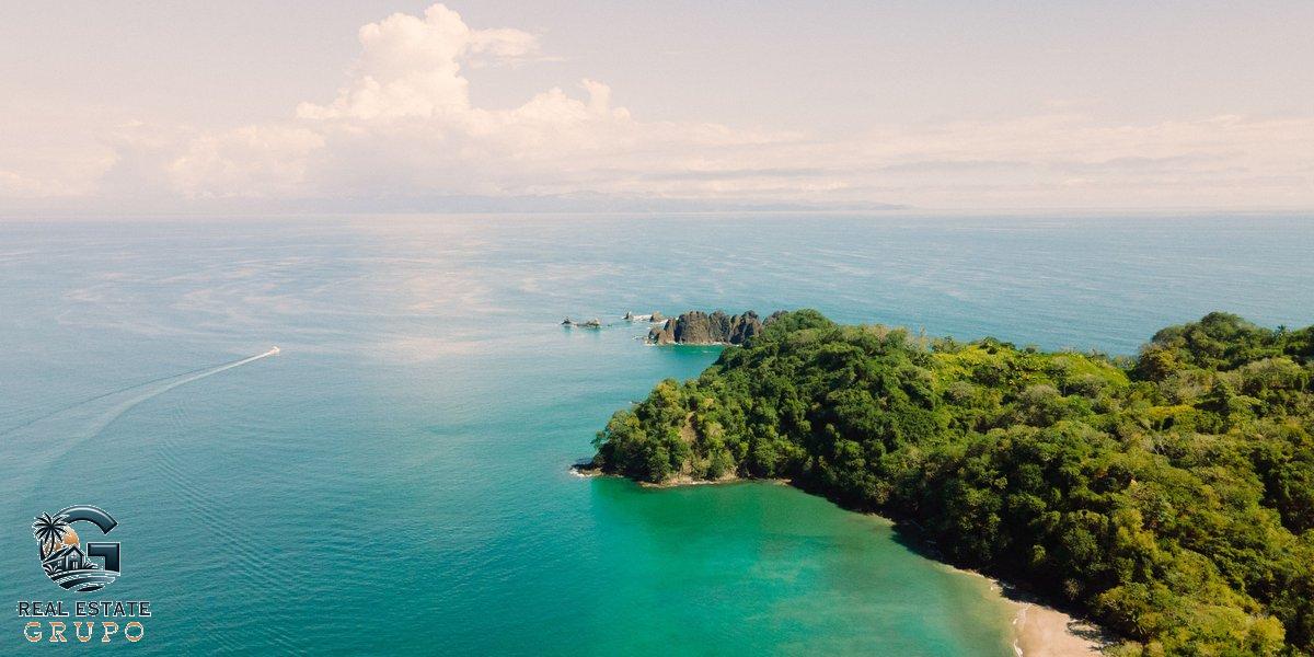 Drone shot tropical island with blue sea - mal pais costa rica real estate