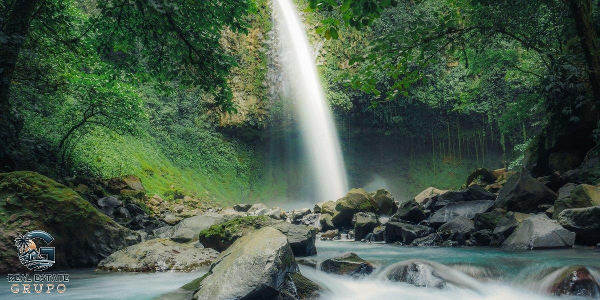 Waterfall cascading through vibrant forest - costa rica registro nacional property report