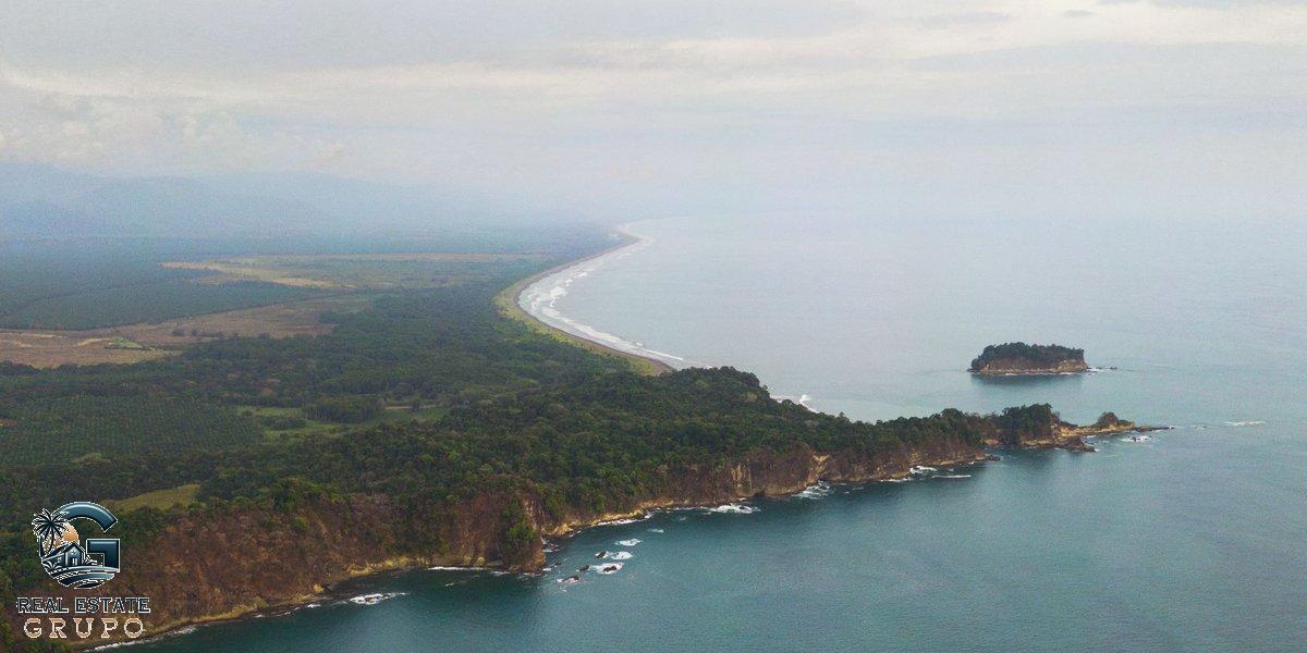 Verdant coastline with calm sea - airbnb rules costa rica